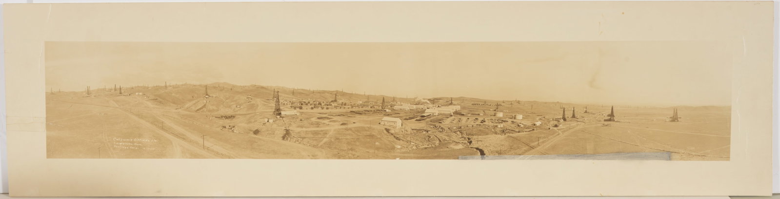 Vintage panoramic photograph of "California Oil Fields, Ltd" in Coalinga, California. Taken by C. W.: Vintage panoramic photograph of "California Oil Fields, Ltd" in Coalinga, California. Taken by C. W. Mealester. Laid down on foam core. 10 x 39.5in. Provenance: From the Rex Stark collection of Gardne