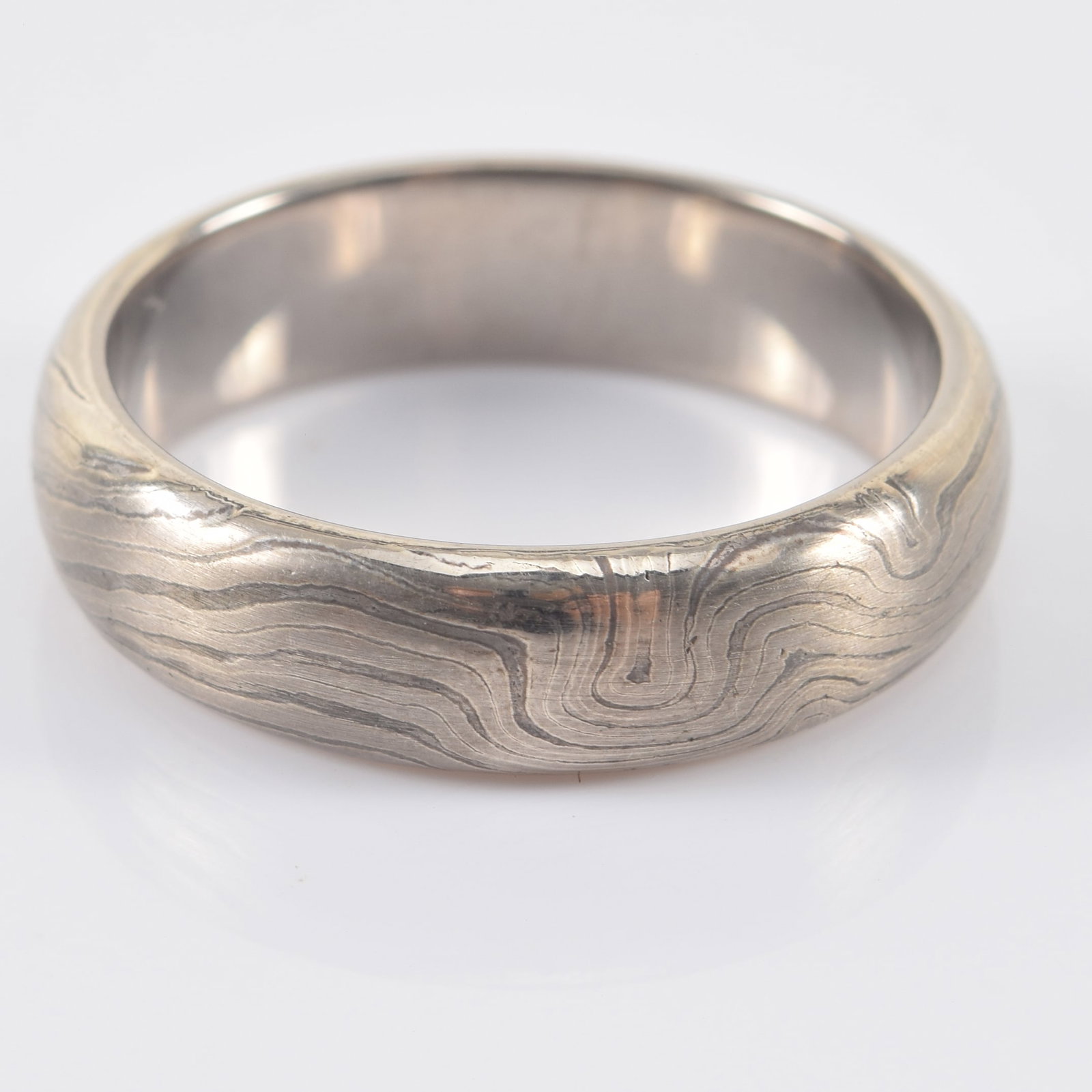 George Sawyer 14K white gold and silver mokume gane ring. Distinctive design of mixed metal "bands".: George Sawyer 14K white gold and silver mokume gane ring. Distinctive design of mixed metal "bands". Stamped 14K and ster. along with maker's mark. Ring size 10. 8.5 grams.