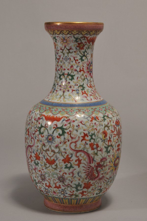 Porcelain vase. China. 19th century. Decoration of: Porcelain vase. China. 19th century. Decoration of bats, dragons and floral scrolling on a pale celadon ground. Ch'ien Lung mark. 14" h.