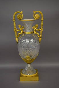 Large Empire style 20th century Continental or Russian: Large Empire style 20th century Continental or Russian gilt bronze mounted two-handle cut glass urn. Figural cherub handles and geometric cut glass urn. Previously mounted as a lamp. 29-1/4" high.