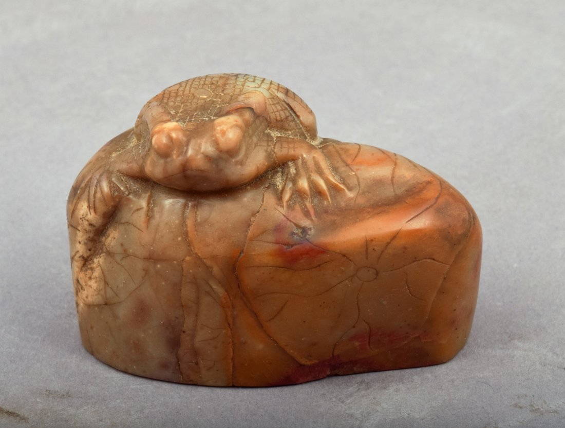 Soapstone seal. China. 19th century. Shou Shan stone.: Soapstone seal. China. 19th century. Shou Shan stone. Finial carved with a frog on a lotus plant. Seal intact. Signed with a cylindrical date. 2-1/2" l. x 1-1/4" w. s 1-3/4" h. This item may have addi