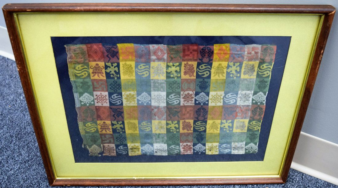 Brocade panel. China. 17th century. Squares of green,: Brocade panel. China. 17th century. Squares of green, yellow, red, blue and white with various Buddhist emblems. (loss). 13" x 9". Framed and glazed. This item may have additional high-resolution phot