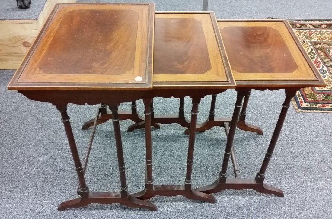 Set of three graduated English Regency style Nesting: Set of three graduated English Regency style Nesting tables. Having mahogany, satinwood, ebony, and rosewood banding and inlay tops. Circa 1900. Height of largest table- 23-1/2". Top dimensions- 19" x