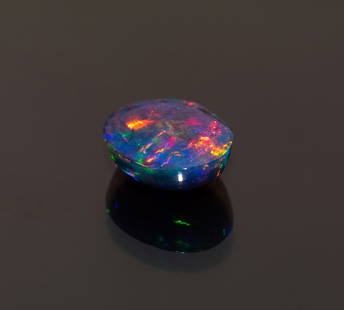 Superb Cabochon Cut Black Opal Natural: This 0.76CT Cabochon Cut Natural Black Opal is an absolute must have if you're collecting opals. As you can see by the pictures, this gemstone appears as if it is on fire - the colors are simply amazi