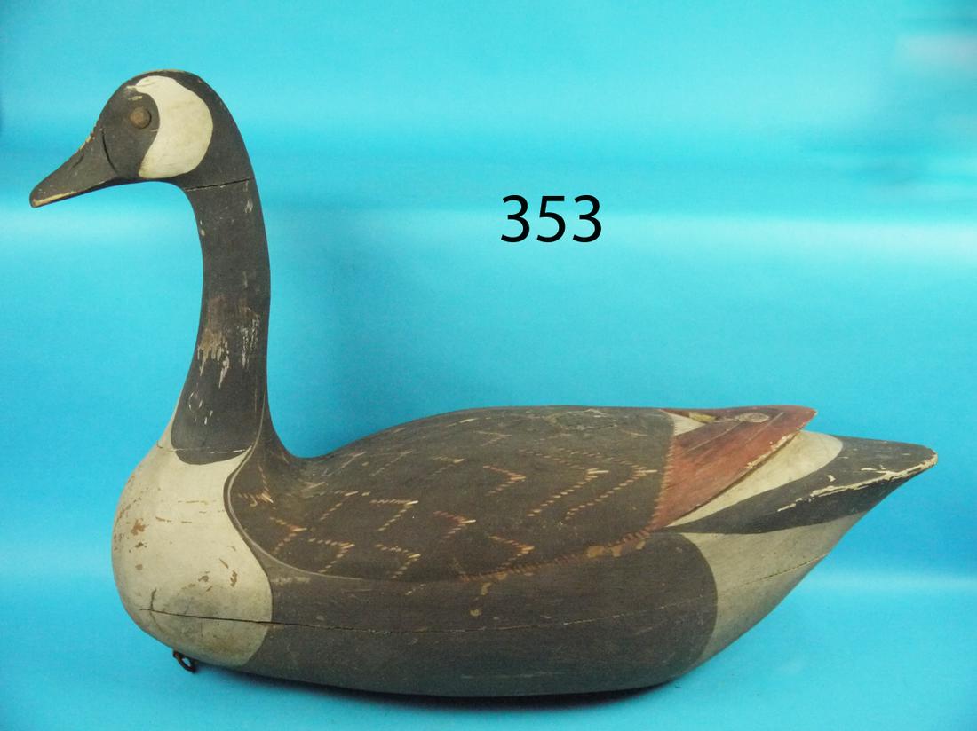 OVERSIZED CANADA GOOSE: OVERSIZED CANADA GOOSE. Old working paint, some which may be original. Some flaking to paint in areas. Carved raised wing tips. Hollow construction. Overall length approximately 28 inches. Height appr