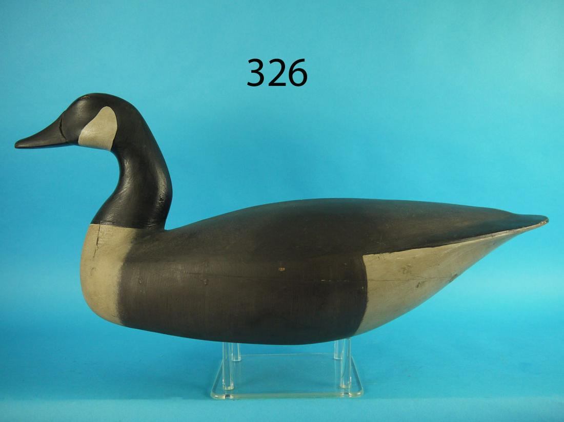 CANADA GOOSE, S. GRANT: EARLY CANADA GOOSE by Stanley Grant, Barnegat, NJ. Very good restored condition. Hollow construction. Carved in a content position. Retains pad weight and rigging thong. An early example of this maker