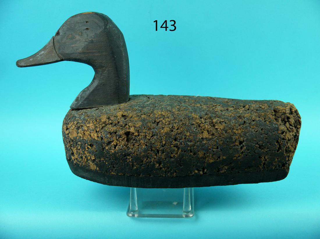 EARLY CORK BLACK DUCK, LONG ISLAND: EARLY CORK BLACK DUCK, Long Island, NY. Remnants of paint overall. Retains wood high head and bottom board. Dog bone weight and rigging ring. An early Long Island decoy. 50-75