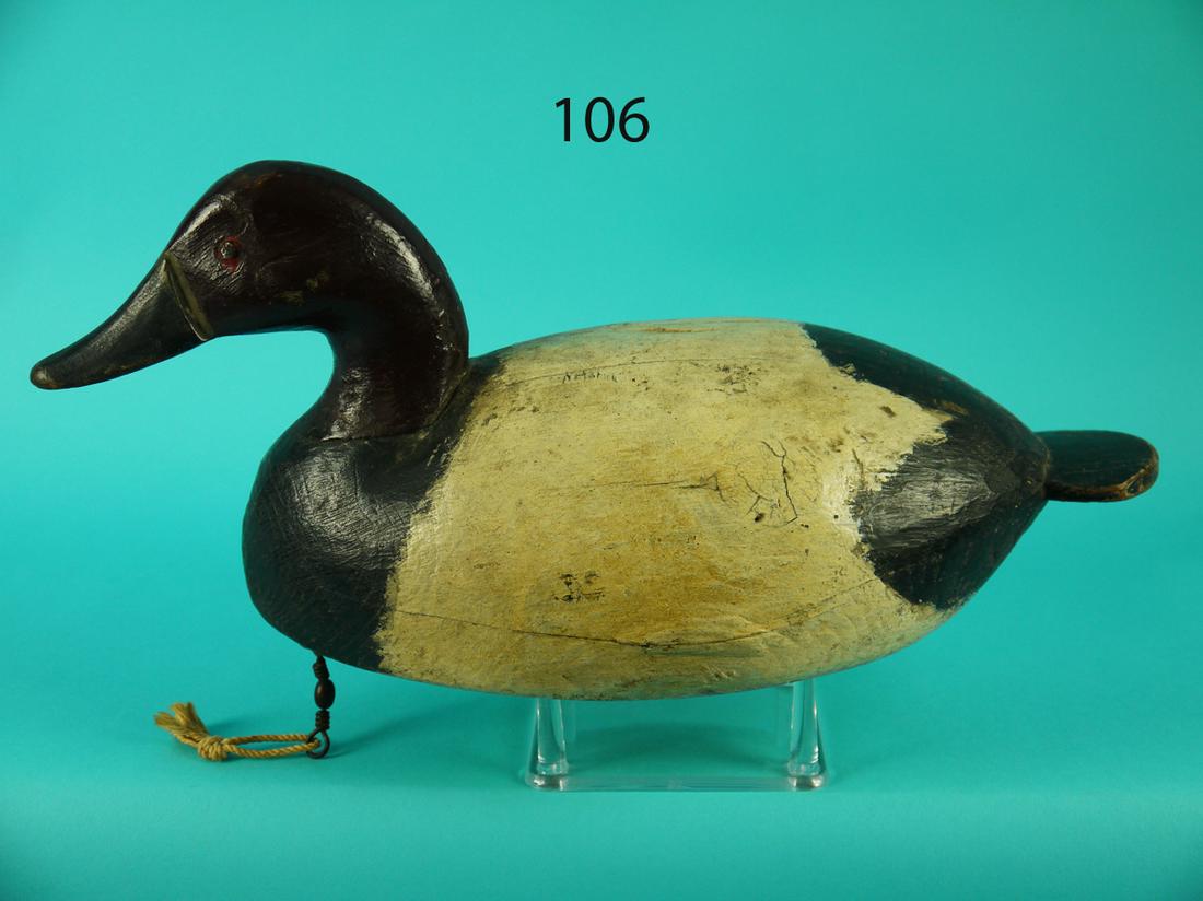 CANVASBACK DRAKE, I. HUDSON: EARLY CANVASBACK DRAKE by Ira Hudson, Chincoteague, VA. Very old working paint and good structural condition. Tight checks to back and underside. Retains glass eyes. Weight removed. Retains leather ri
