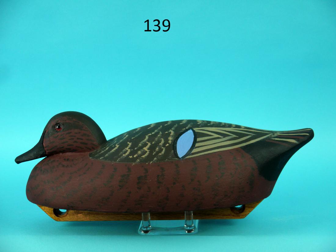 CINNAMON TEAL DRAKE, WILDFOWLER: CINNAMON TEAL DRAKE by the Wildfowler Decoy Co., Oreana, IL. Snug-head model in excellent original paint and condition. Stipple paint pattern overall with cat's eye speculum detail. Retains glass eyes