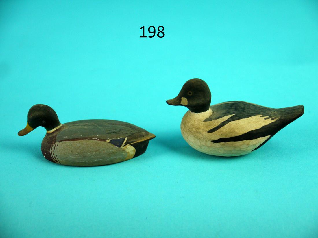 COCKTAIL SIZE MALLARD DRAKE, GOLDENEYE DRAKE: TWO COCKTAIL SIZE CARVINGS, a mallard drake and a goldeneye drake by Dic. Very good original paint and condition. Overall length is approximately 2 1/4 inches. 50-75
