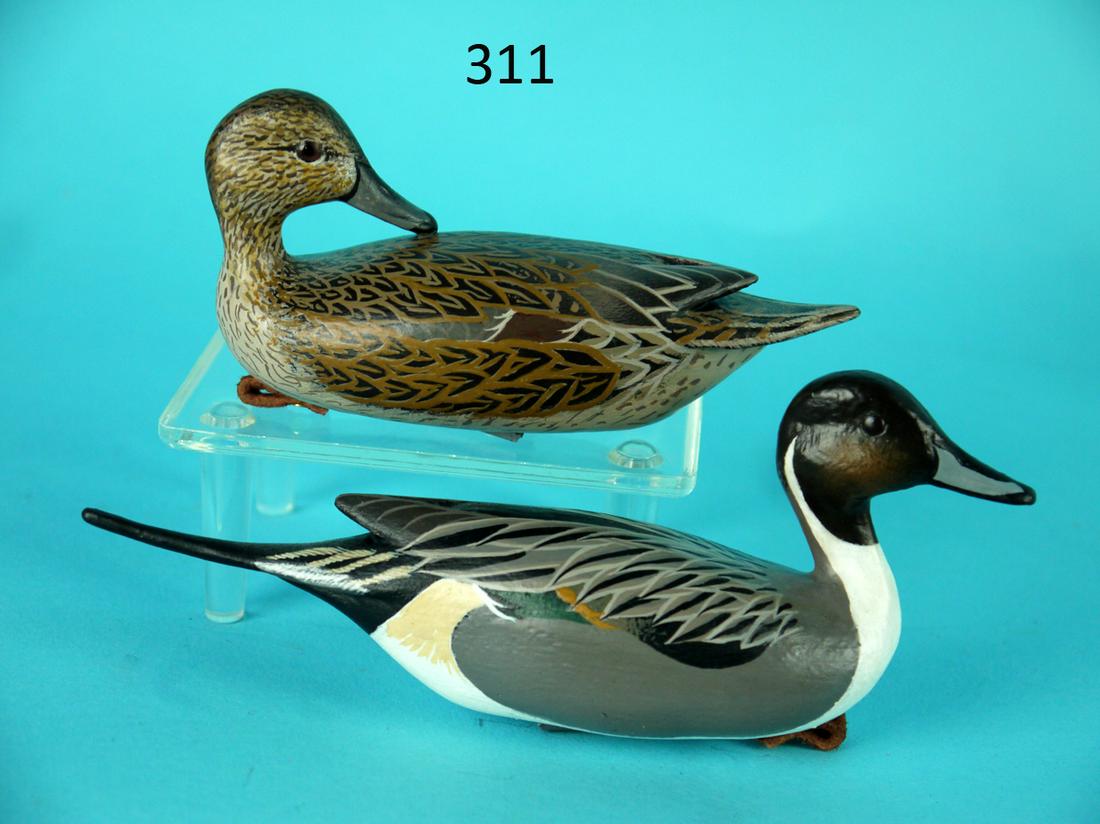 PINTAIL PAIR, COCKTAIL SIZE, J. WOOD: VERY FINE PAIR OF COCKTAIL-SIZE PINTAILS by John Wood, Venice, FL. Excellent original paint and condition. Hen is carved in a preening; the drake is in an alert position. Both with raised carved wing 