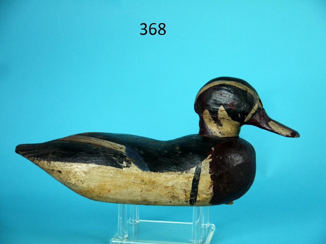 WOOD DUCK DRAKE, DELAWARE RIVER: EARLY WOOD DUCK DRAKE, Delaware River. Original paint preserved with a coat of varnish. Good structural condition with old repair to crack in neck. Raised carved wing tips and fluted tail. Painted eye