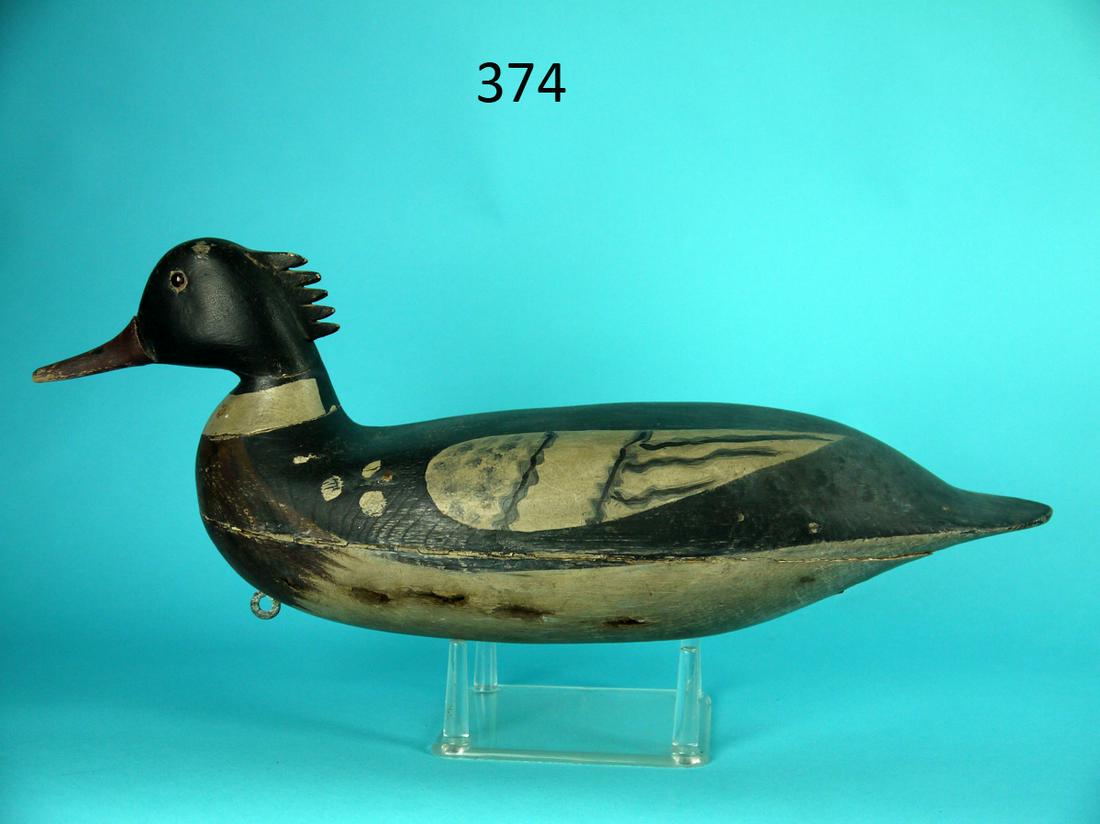 RED-BREASTED MERGANSER DRAKE, S. SOPER: RED-BREASTED MERGANSER DRAKE attributed to Sam Soper, Barnegat, NJ, circa 1900. Restored condition. Hollow construction. Head with five carved combs. Retains glass eyes. Small chip to head above eye. 