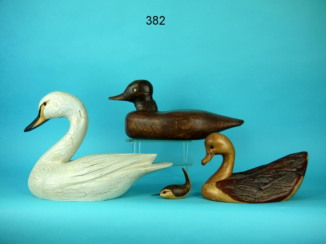 ONE-THIRD SIZE SWAN/MINI HOUSE WREN/TWO DECORATIVE DECOY CARVINGS: ONE-THIRD SIZE SWAN by Paul Arness, King City, CA. Antiqued original paint and very good structural condition. Layered feather carving and split tail. Carved bill detail. Retains glass eyes. Together 