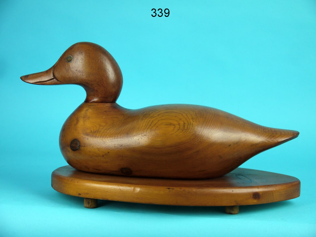 MASON, CHALLENGE GRADE: DECOY by the Mason Decoy Factory, Detroit, MI. Challenge grade in natural wood finish and very good structural condition. Dowelled head is loose but intact. Retains tack eyes. Mounted atop a custom ba