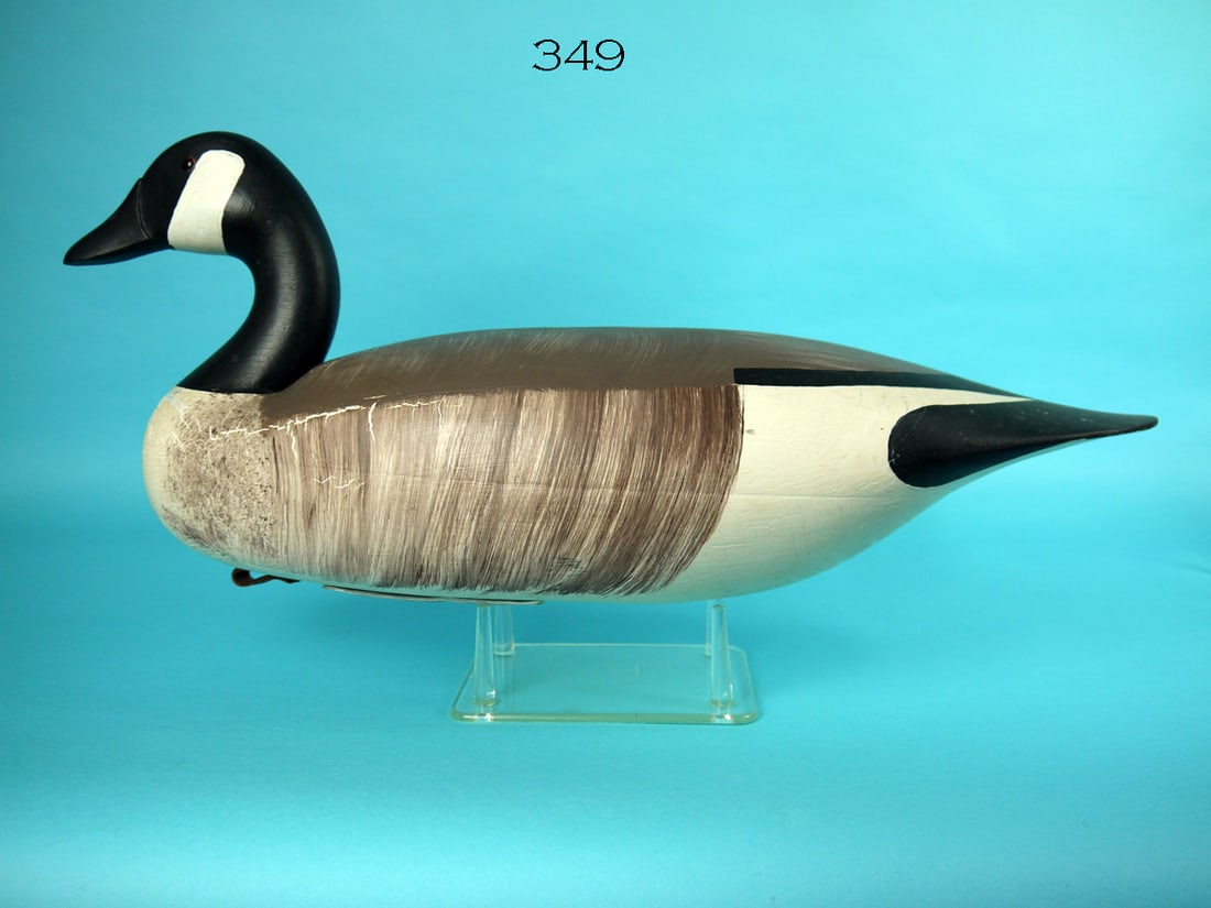 CANADA GOOSE, D. HALL: CANADA GOOSE by Dolph Hall, West Creek, NJ. Original paint with areas of sap bleed to breast, sides and under tail. Fair structural condition with tight check and circular charred area (2") on back. H