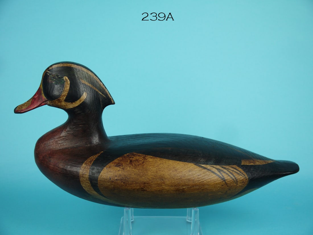 WOOD DUCK DRAKE, T. EASTLAND: FINE WOOD DUCK DRAKE by Timothy A. Eastland, Old Lyme, CT, circa 1980. Very good original antiqued paint and structural condition. Solid construction. Folk-art style paint and raised grain pattern on