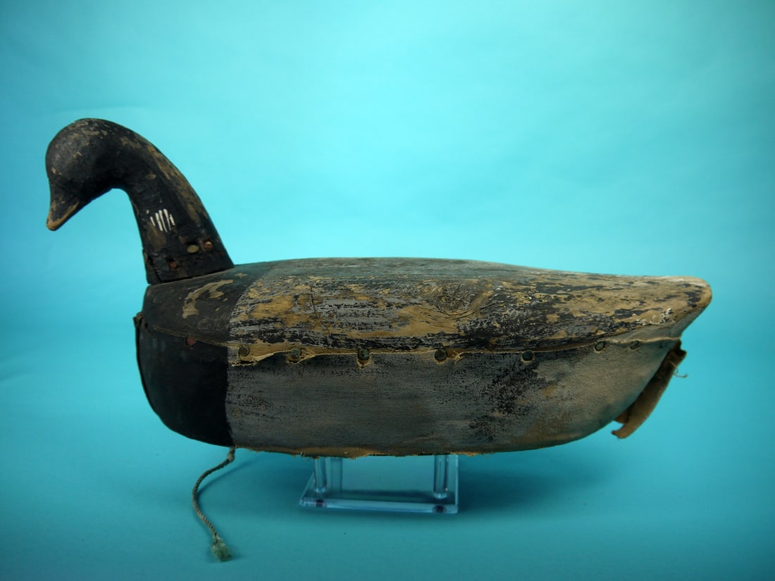 BRANT, VIRGINIA: BRANT, possibly Virginia. Working paint worn to wood in areas. Fair structural condition with several tight checks to body. Head secured with multiple nails. Bottom half of the decoy is covered with