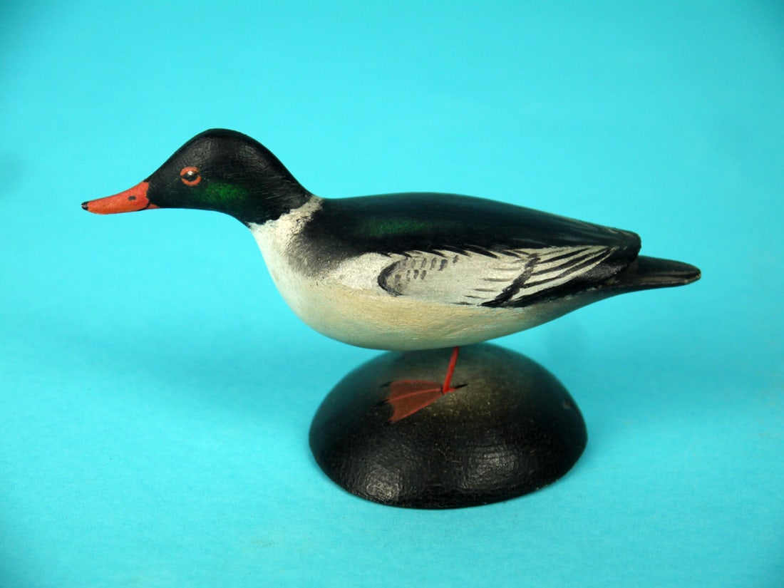 MINIATURE COMMON MERGANSER DRAKE, A.E. CROWELL: VERY FINE MINIATURE COMMON MERGANSER DRAKE by A. Elmer Crowell, East Harwich, MA, (1862-1952). Running model in very good original paint and structural condition. Detailed painted feather detail to