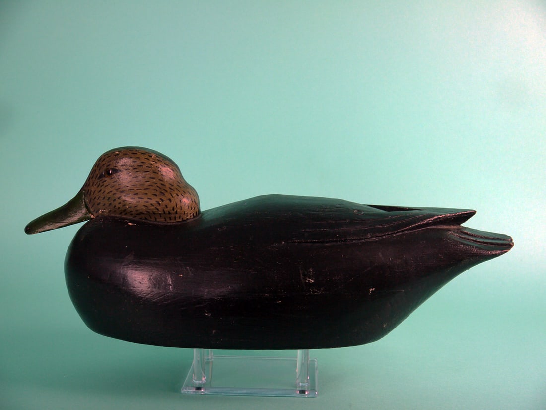 BLACK DUCK, J. MARINKOS: BLACK DUCK by John Marinkos, Florence, NJ. Working paint and very good structural condition. Hollow construction. Snug-head model with raised carved wing tips and fluted tail carving. Painted feather 