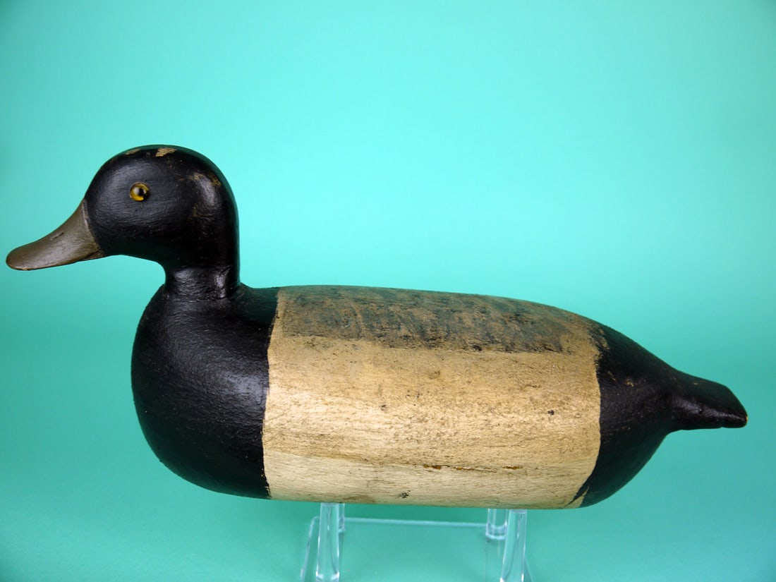 BLUEBILL DRAKE, C. SCHOENHEIDER: BLUEBILL DRAKE by Charles Schoenheider, Peoria, IL. Working paint and very good structural condition. Retains glass eyes, bill with carved detail and strip weight. Overall length is approximately 13
