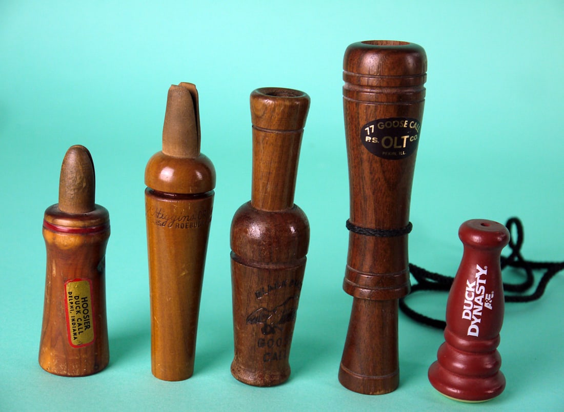 FIVE GAME CALLS: FIVE GAME CALLS consisting of a Hoosier Duck Call, Delphi, IN, a goose call by the P,S. Olt Co., Pekin, IL, a crow call by J.C. Higgins for Sears and Roebuck, a goose call by the Black Duck Co., and