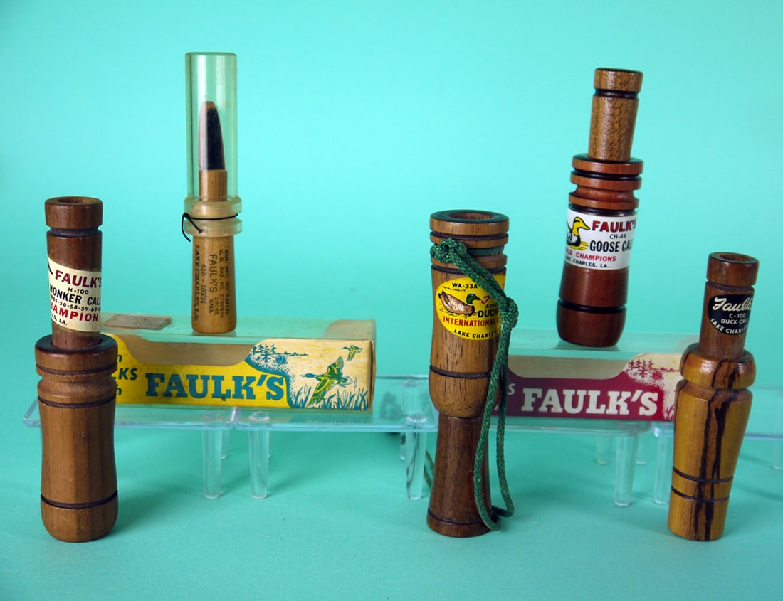 FIVE DUCK CALLS, FAULK'S GAME CALLS: FIVE DUCK CALLS by Faulk's Game Calls, Lake Charles, LA. The group consists of three goose calls (two with boxes) and two duck calls. All in good condition. 75-100