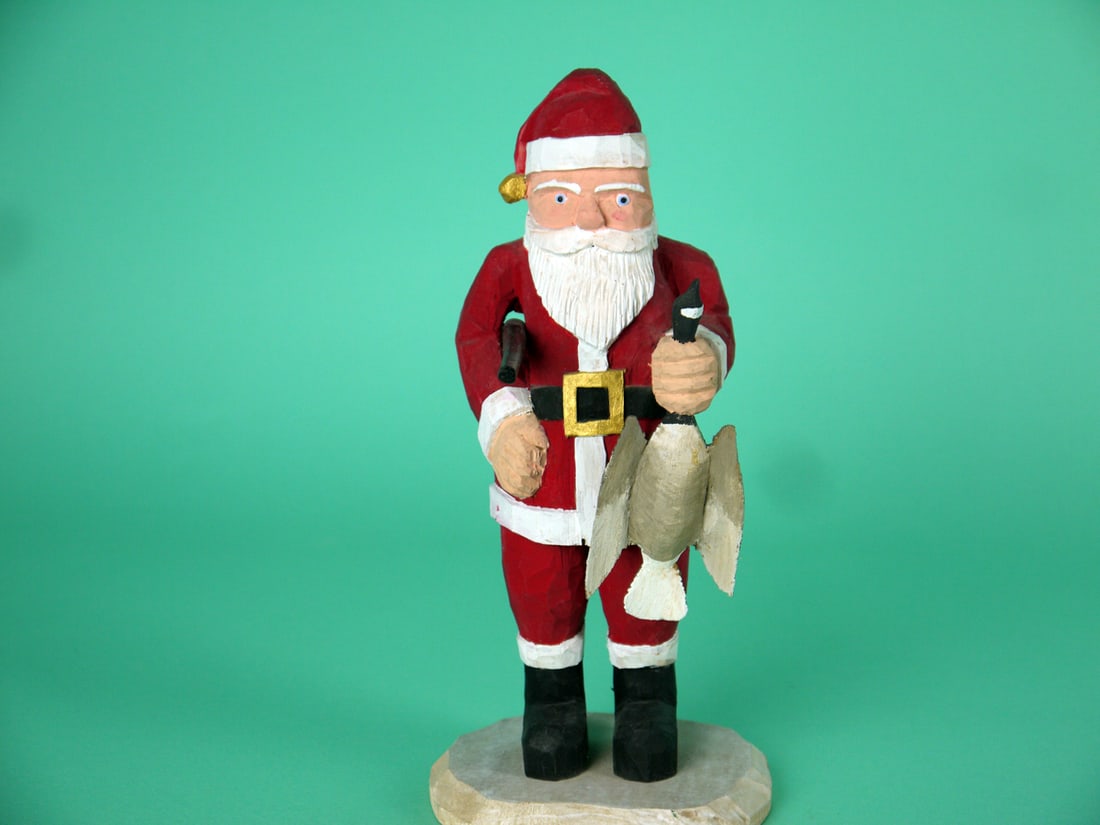 SANTA, H.V. SHOURDS: HUNTING SANTA by Harry V. Shourds, Seaville, NJ. Very good original paint and structural condition. Chip-carved style with carved detail to face, hat and outfit. Grasping a Canada goose in one hand
