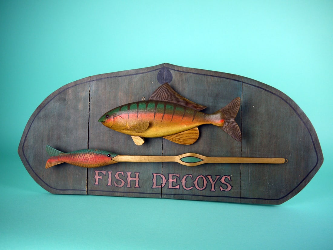 FISHING PLAQUE, L. RENIERI: FISHING PLAQUE by Lou Reineri, Chincoteague, VA, titled FISH DECOYS. Both carved pieces are in very good condition with carved fins gills and glass eyes. Mounted on a four-piece plaque, with one