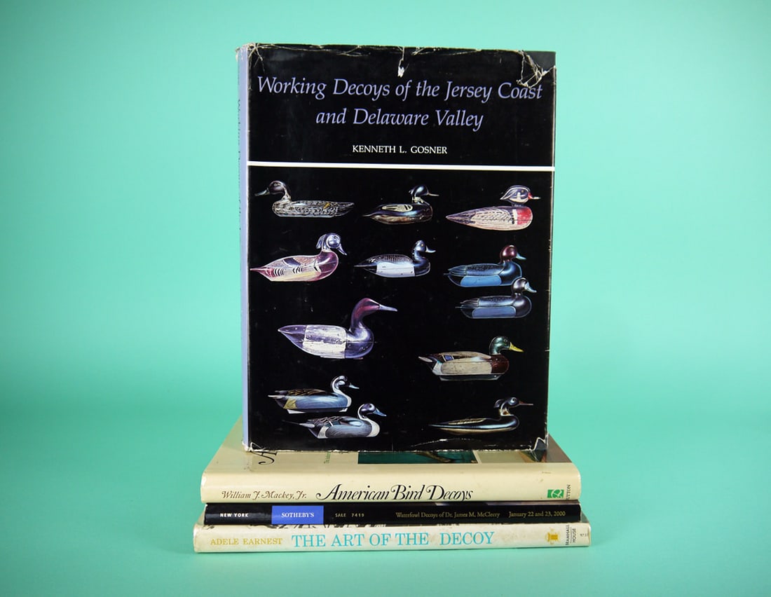 FOUR DECOY BOOKS: GROUP OF DECOY-RELATED BOOKS consisting of "Working Decoys of the Jersey Coast and Delaware Valley" by K. Gossner. Good condition with some small tears to dust jacket. Owner's name written on flyleaf,