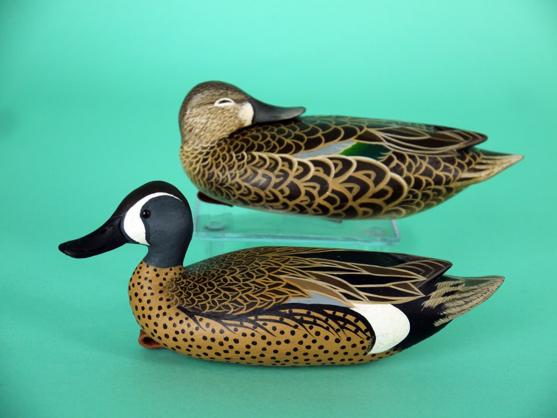 MINIATURE BLUE WING TEAL PAIR, J. WOOD: VERY FINE PAIR OF MINIATURE BLUE WING TEAL by John Wood, Venice, FL. Excellent original paint and structural condition. Very detailed painted feather work to both bodies. Both with raised wing tips.