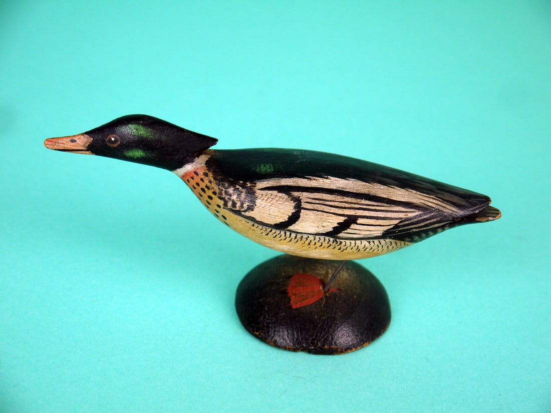 MINIATURE RED-BREASTED MERGANSER: MINIATURE RED-BREASTED MERGANSER DRAKE, carved in the style of A.E. Crowell. Very good original paint and structural condition. Running model with detailed painted feather work to body. Head with