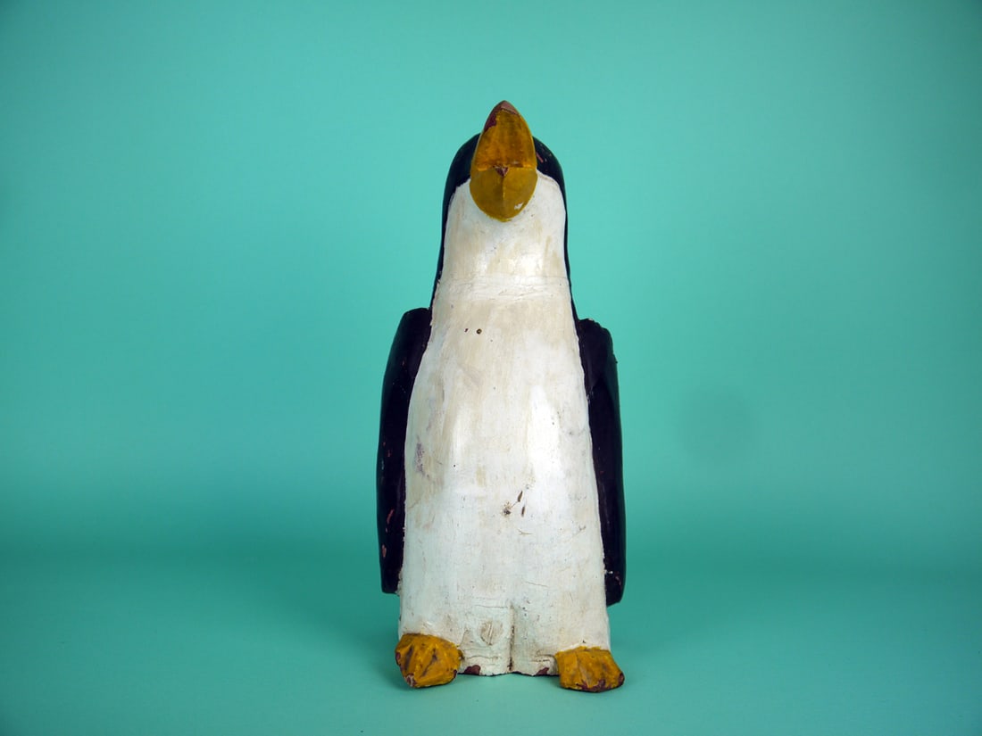 ONE-HALF SIZE PENGUIN: ONE-HALF SIZE PENGUIN, unknown maker. Good original paint with some flaking to body and bill tip. Neck seam visible. Solid construction. Plump folk art model with carved eyes, wings and feet. Open
