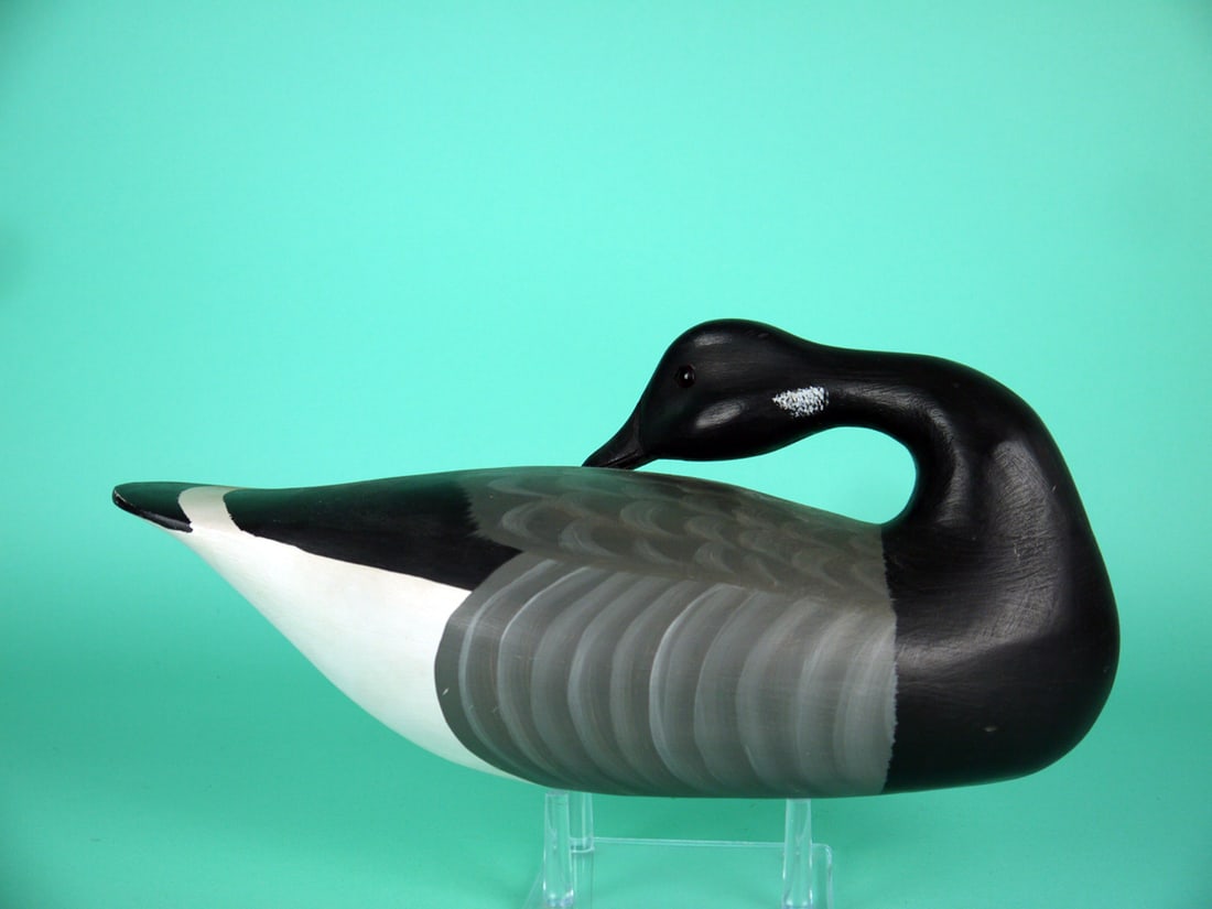 PREENING BRANT, H.V. SHOURDS: BRANT by Harry V. Shourds, Seaville, NJ. Very good original paint and structural condition. Some shelf rubs to underside. Hollow construction. Preening model with painted feather detail to back and