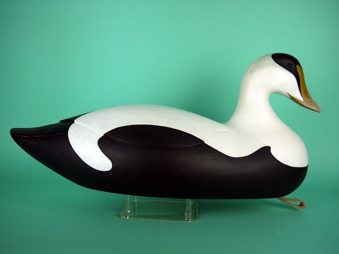 EIDER, G. AVADANIAN: EIDER by Gary Avadanian, Reading, MA. Very good original paint and structural condition. Hollow construction. Deluxe folk art model with relief-carved wing detail and fluted tail. Head retains glass e