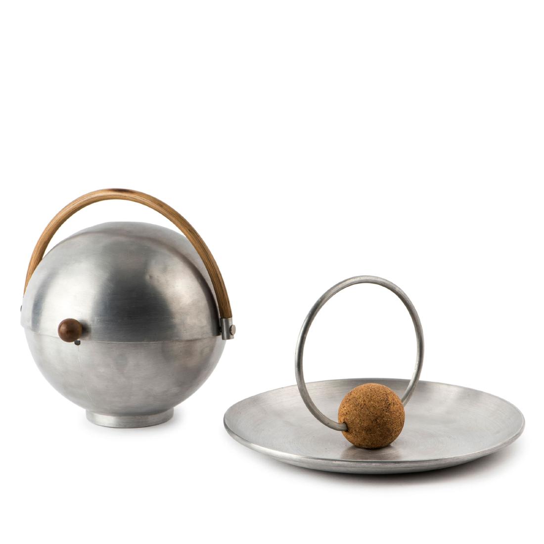 'Bun warmer' and fruit bowl, c1930: Russel Wright, Bun warmer: H. 24 cm, D. 25 cm; fruit bowl: H. 18 cm, D. 30.5 cm. Aluminium, rattan, wood, cork. Marked: RUSSEL WRIGHT.