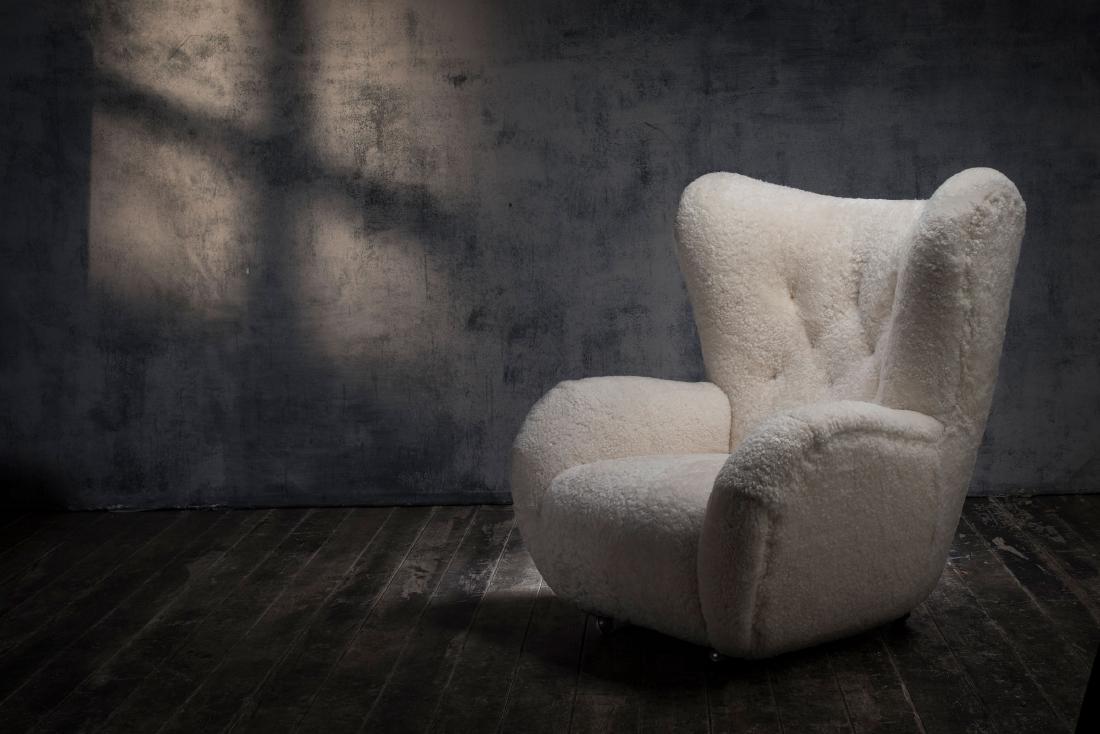 Armchair 'The Tired Man', 1930/40s: Flemming Lassen (attributed), H. 94 x 87 x 90 cm. Made by Jacob Kjaer, Copenhagen (attributed). Wheels, white sheep skin.