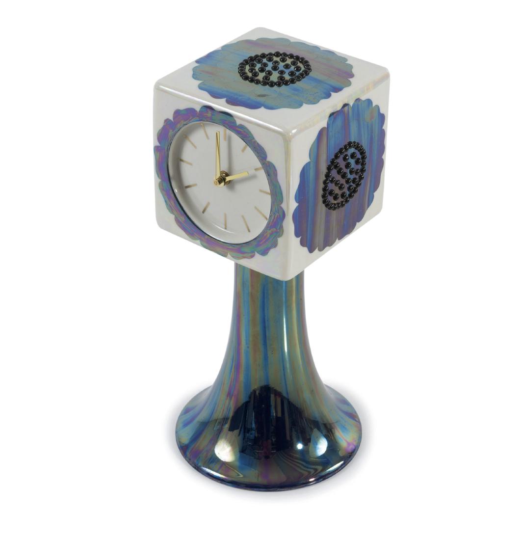 Table clock, 1960s: Birger Kaipiainen, H. 37.8 cm. Made by Arabia, Helsinki. Porcelain, white, glazed, glazed blue and white, applied nodes, lustred; brass hands. Marked: Facsimile signature Birger Kaipiainen, ARABIA FIN