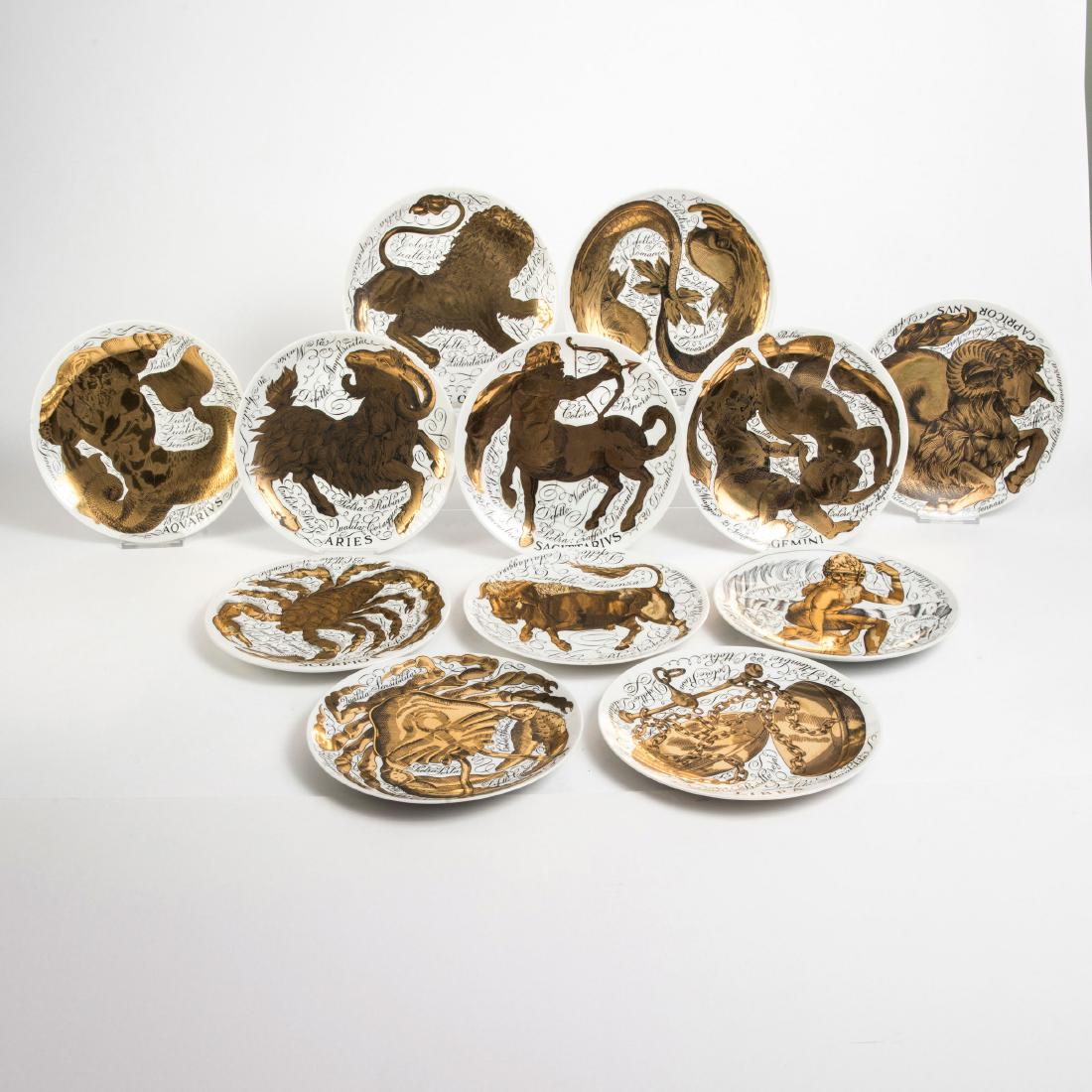 Twelve 'Gli influssi astrali' plates, 1975: Piero Fornasetti, D. 21.3 cm. Made by Fornasetti, Milan, in 1975. Earthenware, white, glazed black and white lithograph with gold. Marked: GLI INFLUSSI ASTRALI - SERIE SPECIALMENTE CREATA DA PIERO FOR