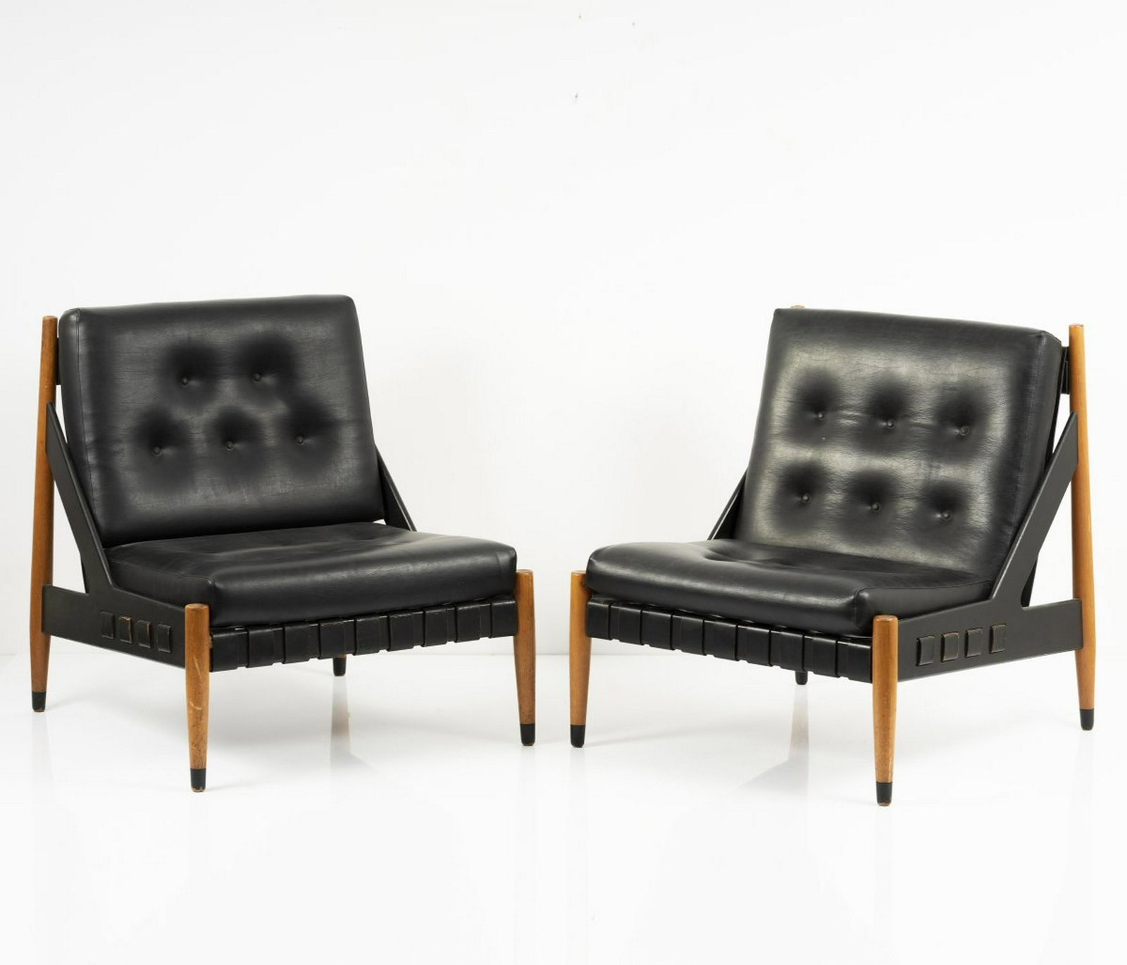 Egon Eiermann, Two 'SE 12' easy chairs, 1969: Egon Eiermann, Two 'SE 12' easy chairs, 1969, H. 82 x 72 x 72.5 cm. Made by Wilde & Spieth, Esslingen, c. 1969. Beech, part black, black leatherette and straps. , Egon Eiermann die Moebel, p. 114ff.