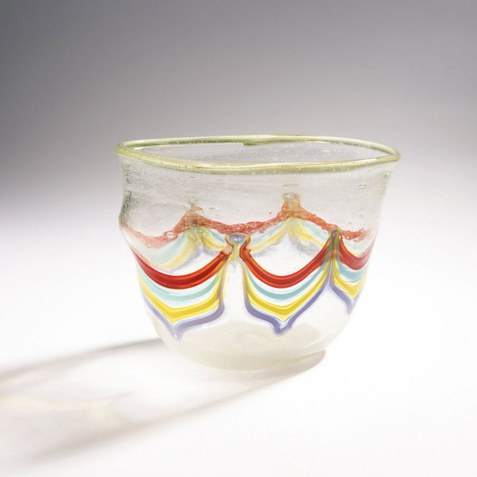 Anzolo Fuga, 'Pavone' vase, 1957-60: Anzolo Fuga, 'Pavone' vase, 1957-60, Oval shape. H. 18.5 cm; 26.5 x 15.5 cm. Execution: A.Ve.M. Bubbly cased glass, clear, 'Pavone' decor (peacock feather) with melted bands in yellow, turquoise, red 