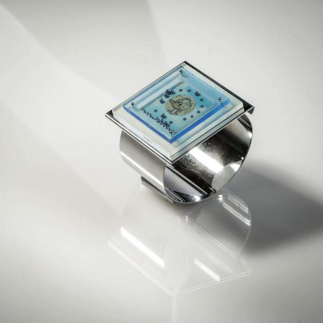 Gerd Rothmann, Bangle with interchangeable plate, 1973: Gerd Rothmann, Bangle with interchangeable plate, 1973, Brass, chromed, Plexiglas, steel balls, paper. 80 grams. Plate 5 cm x 5 cm. D. c. 6.5 cm. Signed: Rothmann 1973 (engraved)., Cf. Rothmann, Werkv