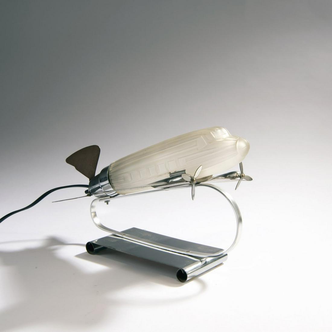 Sarsaparilla Deco Designs, 'Dakota DC 3' table light,: Sarsaparilla Deco Designs, 'Dakota DC 3' table light, 1930s, H. 19.5 x 33 x 34 cm. Sheet aluminium, clear matt moulded glass. Marked: Maker's stamp and label; in the glass: maker's mark, 1978. ,