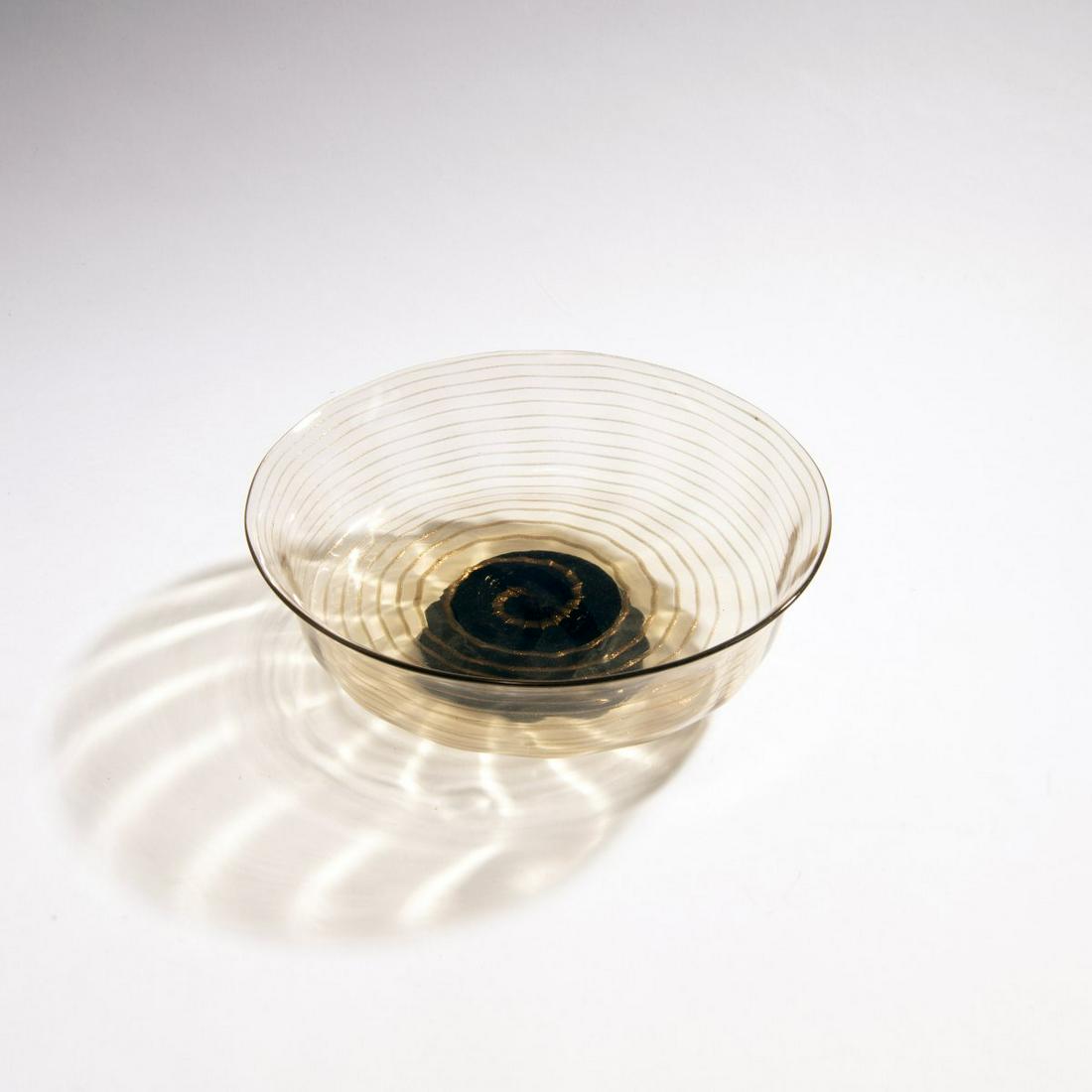 Ercole Barovier, 'Spirale avventurina' vase, c. 1925-30: Ercole Barovier, 'Spirale avventurina' vase, c. 1925-30, H. 7 cm. D. 22 cm. Execution: Vetreria Artistica Barovier & C. Light amber tinted glass, spiral thread in avventurine. Dark purple foot. Signed