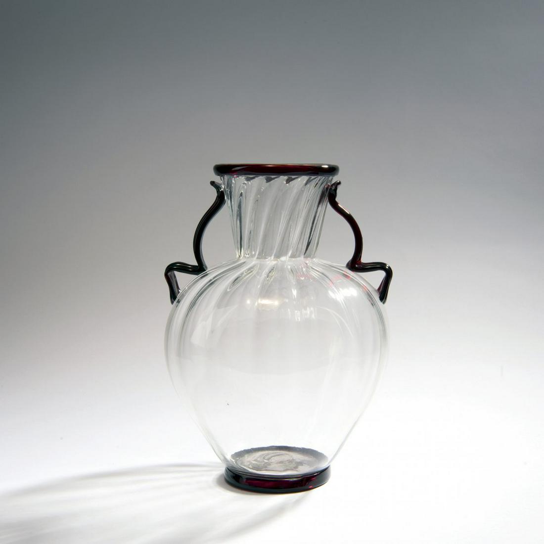 Ercole Barovier, Vase, c. 1930: Ercole Barovier, Vase, c. 1930, H. 31.5 cm. Execution: Vetreria Artistica Barovier & C. Clear glass, vertical rib optics, handle, mouth and base ring ruby red.,