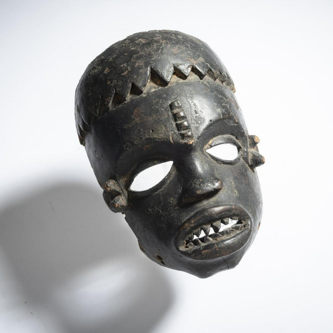 Ibibio, Nigeria, Face mask of the 'Ekpo' association: Ibibio, Nigeria, Face mask of the 'Ekpo' association, Mouth with 2 rows of teeth, tattooing on the forehead. Crusty patina. H. c. 21 cm. Old collection number with white ink: 228-78.,