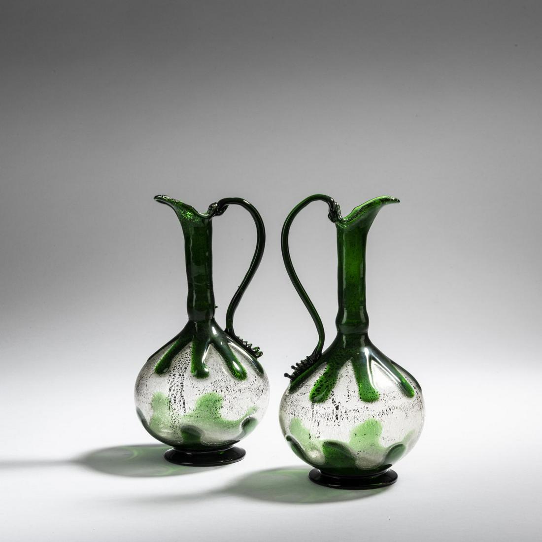Fratelli Toso, Two 'Stile antico' carafes, c. 1910: Fratelli Toso, Two 'Stile antico' carafes, c. 1910, H. 19 cm. Glass, clear, green, burst metal foil, model 1724., Marc Heiremans, Fratelli Toso Murano 1902 - 1980, Stuttgart 2018, p. 31.
