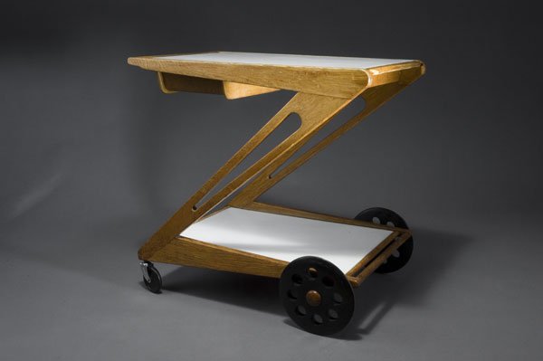 Cees Braakman. Tea trolley, designed c. 1955. H.: Cees Braakman. Tea trolley, designed c. 1955. H. 61.5 x 67 x 50 cm. Made by UMS Pastoe, Utrecht. Oakwood, plywood, white formica, bakelite. Marked: Maker's stamp.