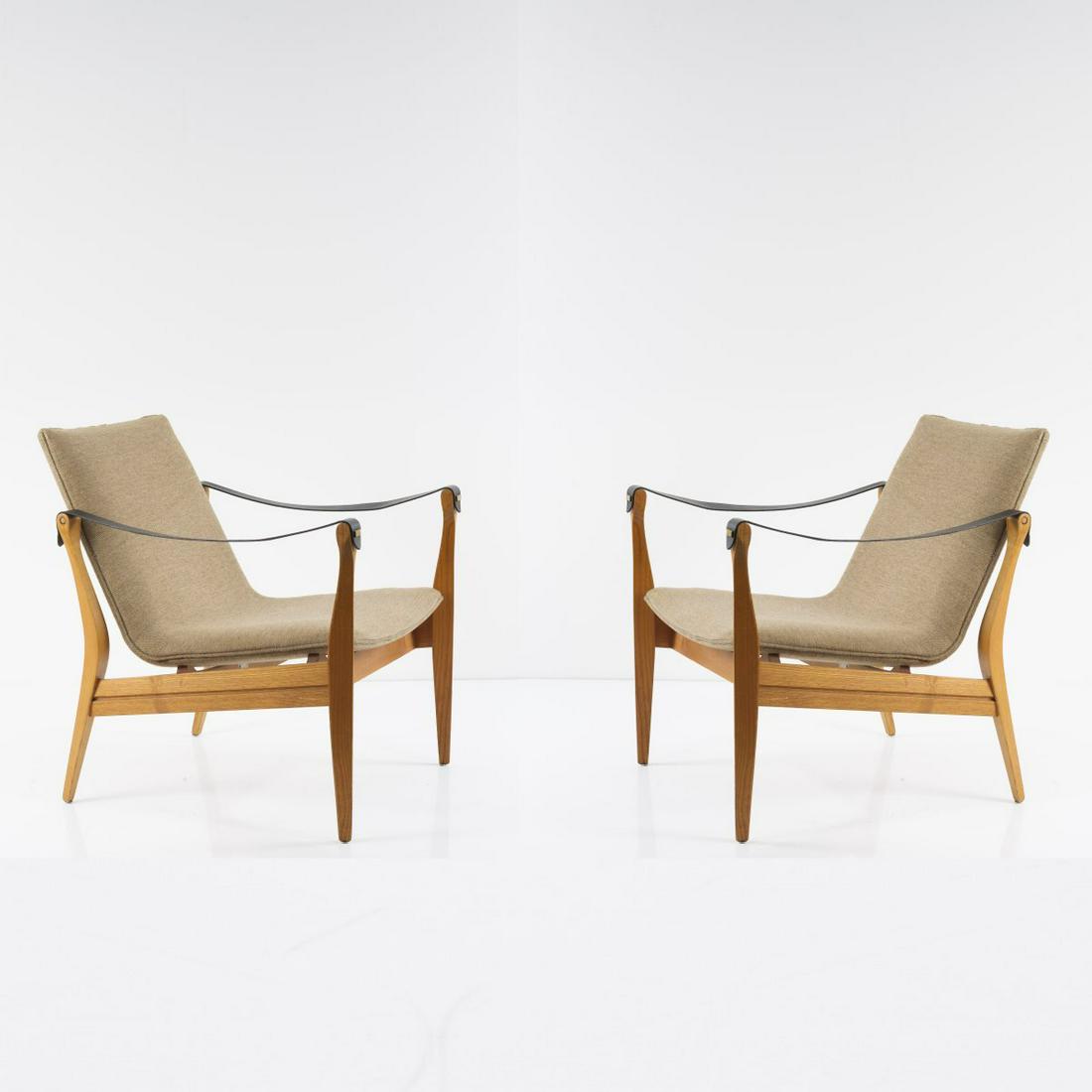 Ebbe Clemmensen; Karen Clemmensen, Two easy chairs: Ebbe Clemmensen; Karen Clemmensen, Two easy chairs '4305', 1963, H. 71.5 x 63 x 67 cm. Made by Fritz Hansen, Allerød. Ash wood, beige textile cover, black leather straps, brass. Marked: manufac