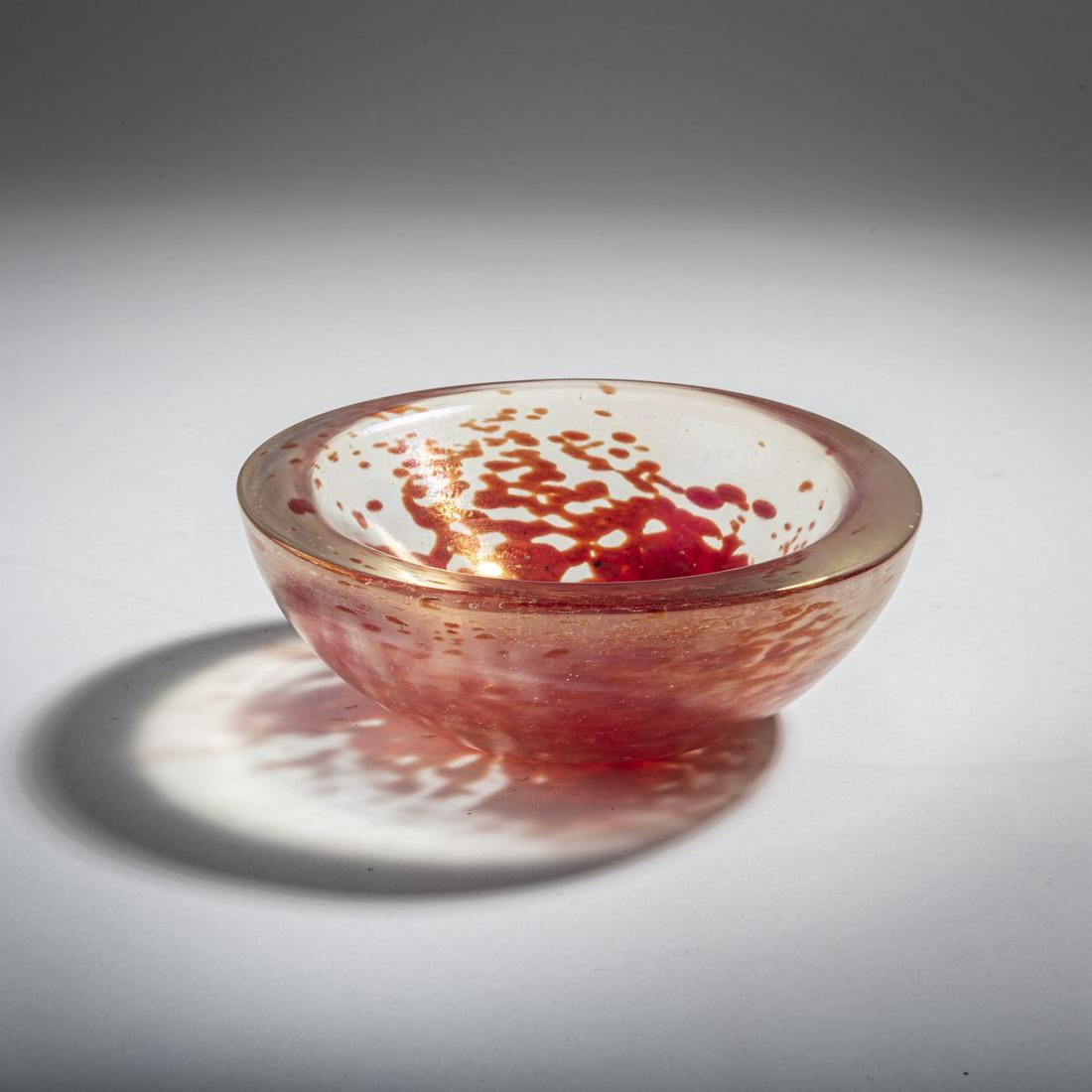 Dino Martens, 'A mace' bowl, c. 1950: Dino Martens, 'A mace' bowl, c. 1950, H. 5.4 cm; D. 15.5 cm. Execution: Aureliano Toso. Cased glass, colorless with powder inclusions in orange, iridescent. Adhesive label on the bottom: Made in Italy